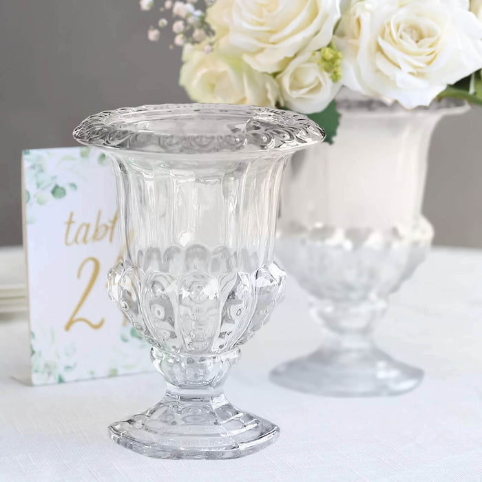 Clear decorative vase with intricate design, perfect for floral arrangements.