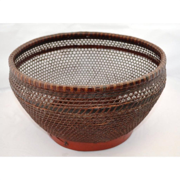 Brown woven rattan storage basket with wide opening and intricate lattice pattern, close-up view.