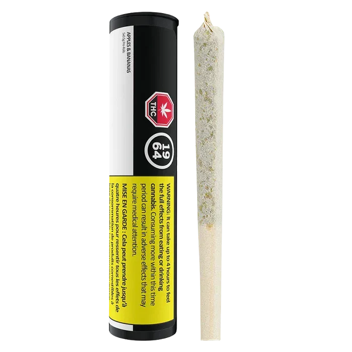 Vertical product shot of Apples & Bananas PR 5 x 0.5 g showing the black cylindrical tube with warning labels beside a close-up of the rolled joint.
