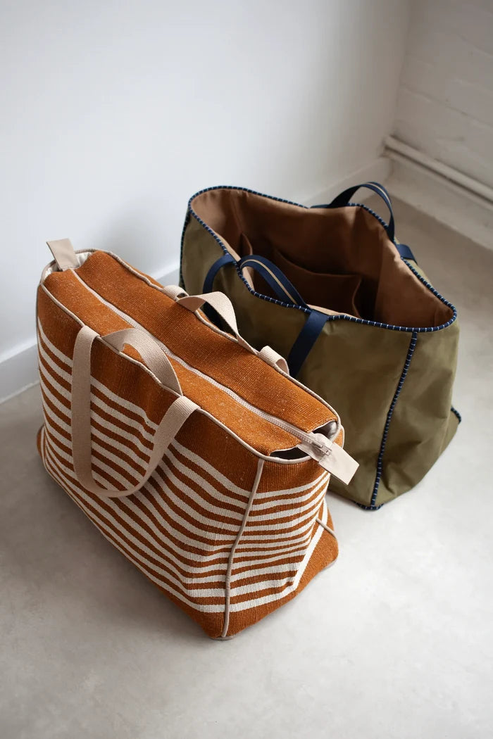 Two tote bags, one brown with white stripes and one green, made using the Away Tote PDF Sewing Pattern  on a light surface.