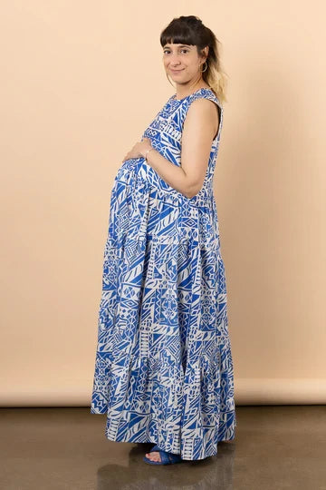 Woman wearing a blue patterned dress  made using Azure Dress, Skirt, and Top sewing patternagainst a beige background