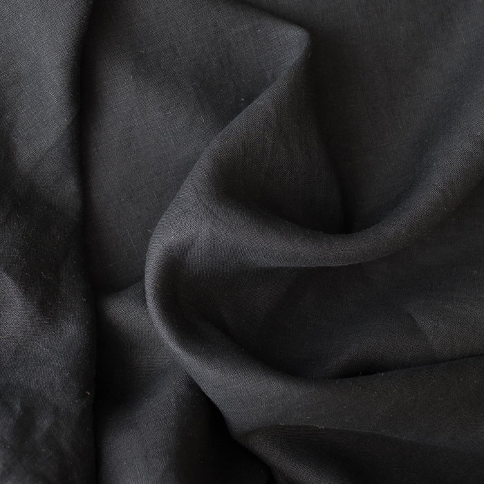 Close-up of black linen fabric with folds