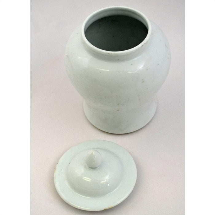 White porcelain Blanc de Chine bell jar with removable lid on a light surface, close-up.