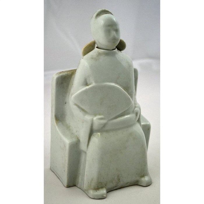 White Blanc de Chine porcelain doll, faceless seated woman holding fan, minimalist décor on tabletop.