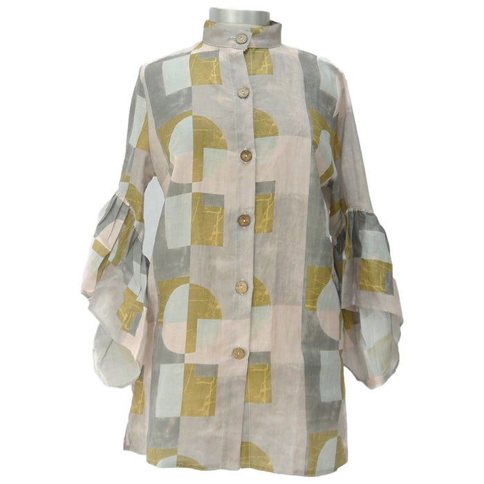 A high neck linen blouse with bell ruffle sleeves, featuring a color blocked geometric pattern in shades of pink, gray, aqua, and blush, with buttons made from smoothed raw coconut shells.