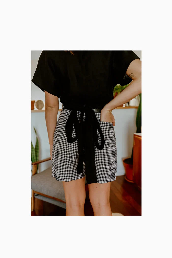 Lady wearing blach gingham  shorts  made of Bottlebrush Pants and Shorts Sewing Pattern - High-Waisted Flared Pants and Mini Shorts