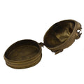 Close-up of a round brass box with a hinged lid and antique detailing, Brass Monkey Head Box.