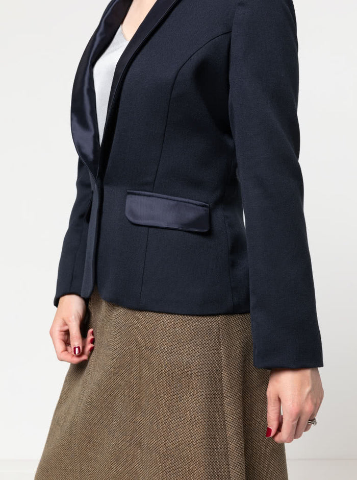 Navy blazer made using the Bronnie Tuxedo Jacket Sewing pattern  worn by a person on a plain background