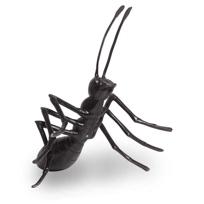 Bronze metal ant statue with six legs and two antennae, outdoor garden decor, close-up view.