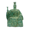 A bronze sculpture of a Qing Dynasty Emperor wearing a green and brown robe, seated on a throne with a textured patina to simulate antiquity.