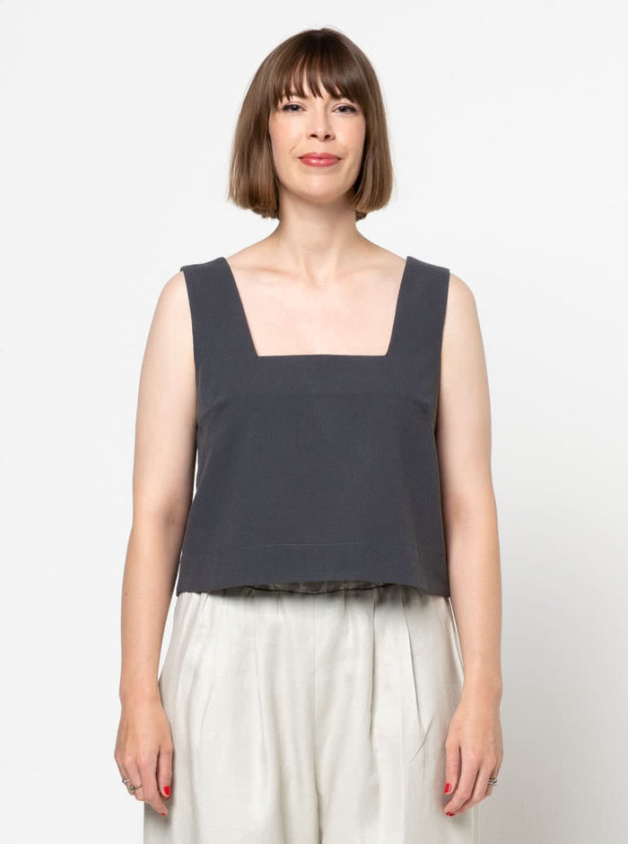 Image of the Byron Woven Top sewing pattern, highlighting the square neck, sleeveless design, and deep hem facing with topstitching, suitable for various elegant fabrics.