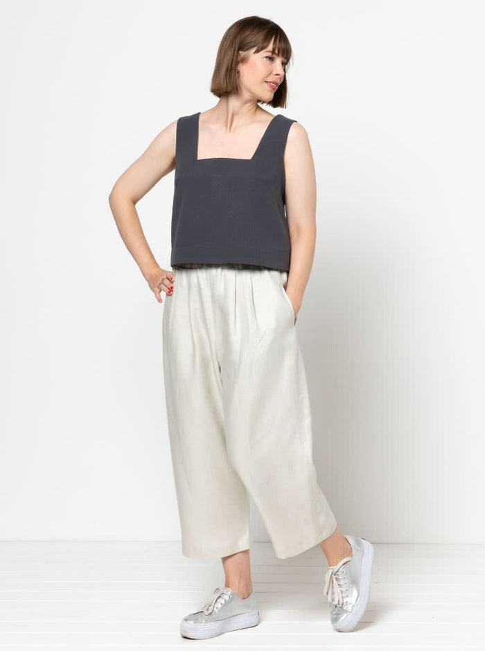 Image of the Byron Woven Top sewing pattern, highlighting the square neck, sleeveless design, and deep hem facing with topstitching, suitable for various elegant fabrics.