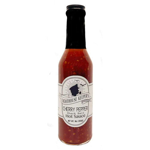 A jar of Cherry Pepper Shark Bait Hot Sauce with a label that includes the brand name and product description.