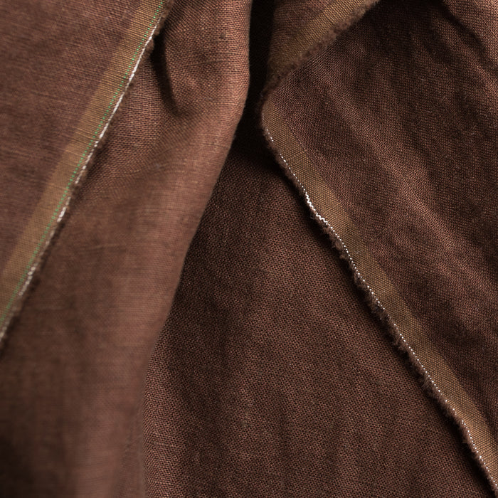 Close-up of Cocoa extra wide 100% linen fabric  with a visible seam