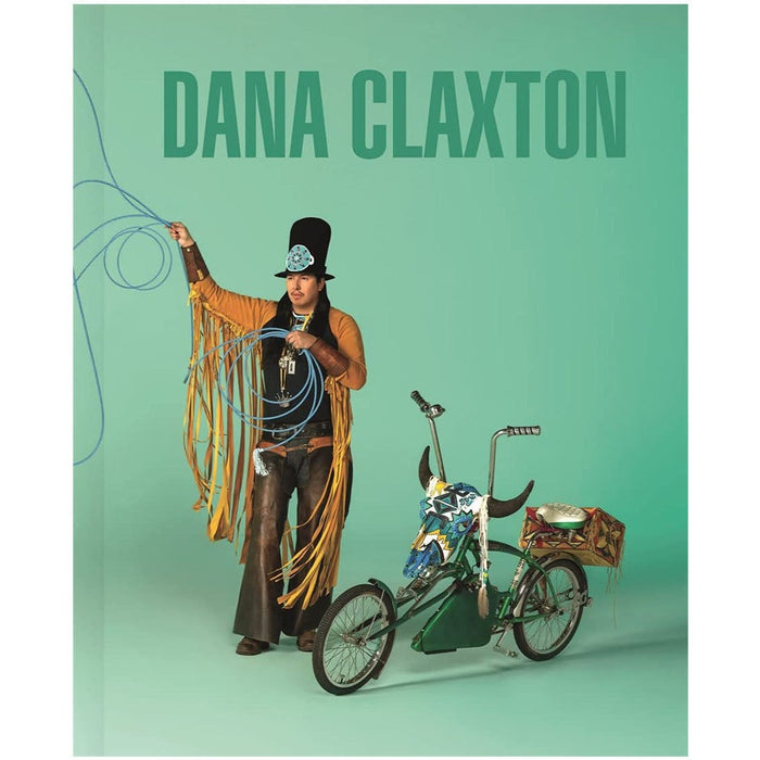 Cover of the book featuring a person in an artistic performance setting, dressed in a headdress and holding a whip next to a bicycle, against a green background.
