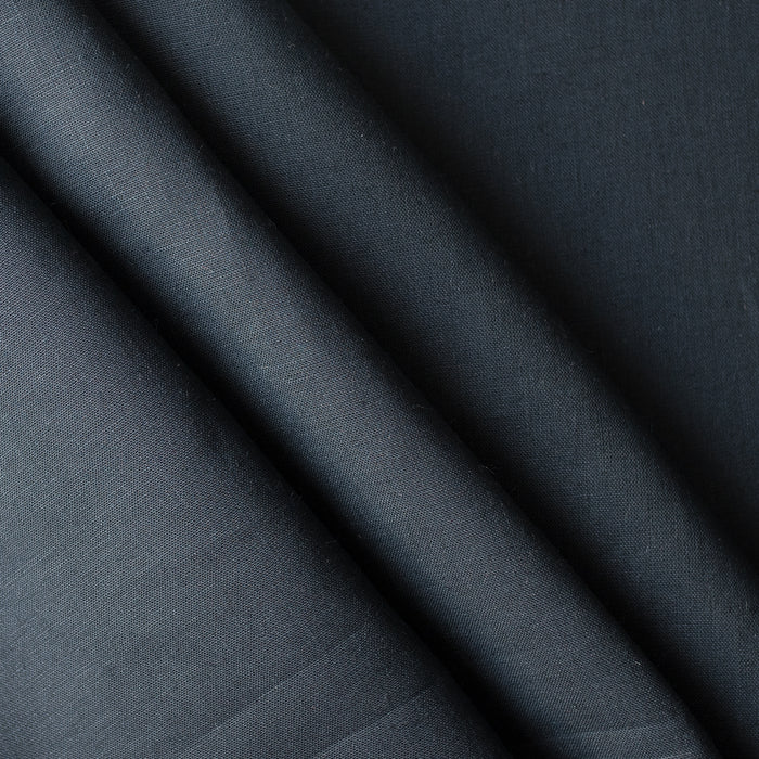 Close-up of dark  navy blue linen fabric with folds