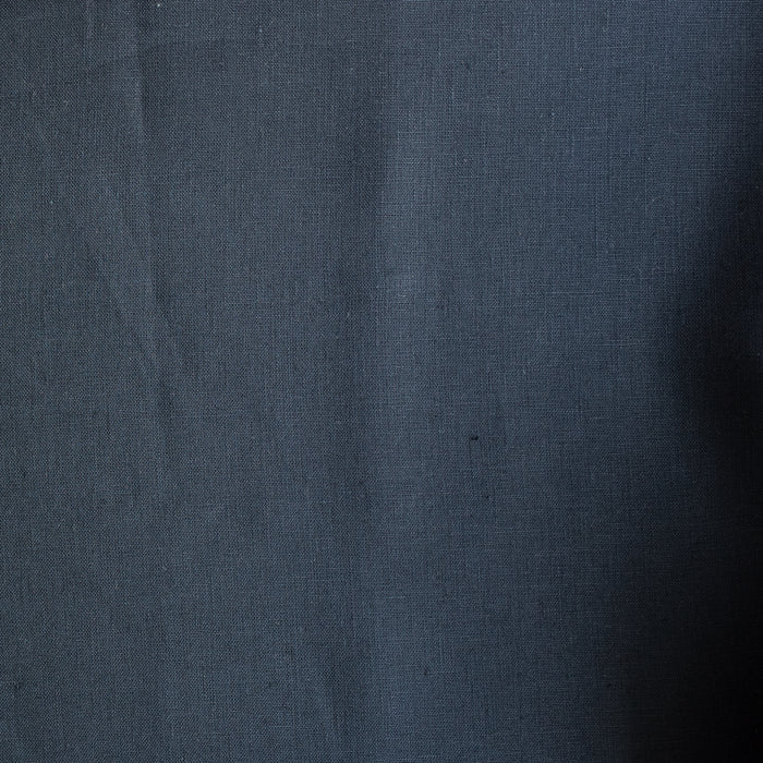 Close-up of dark  navy blue linen fabric with folds