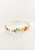 A ring with a mix of crystals in different shapes and colors.