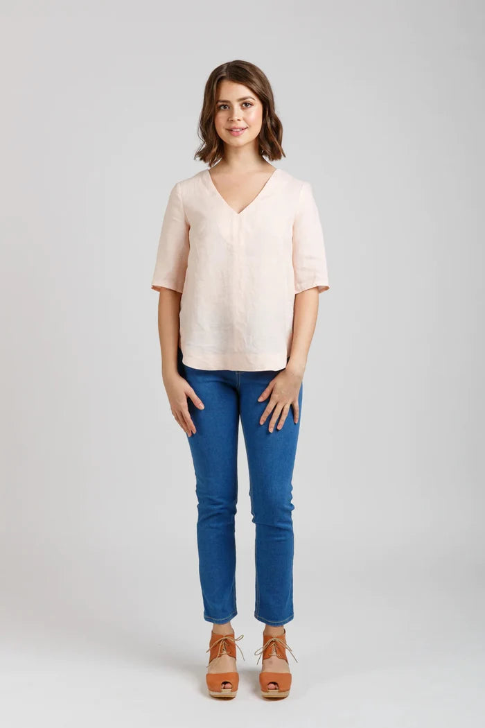 Dove blouse sewing pattern by Megan Nielsen with statement sleeve cuffs, french darts, v neckline, and curved hemline, available in three sleeve variations.