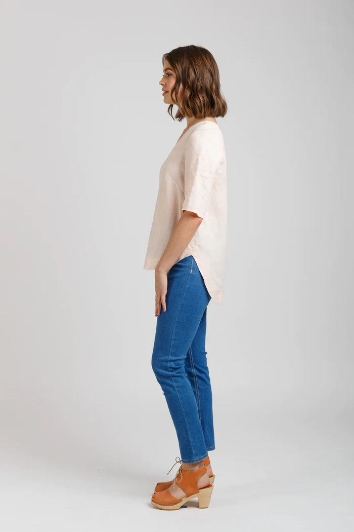Dove blouse sewing pattern by Megan Nielsen with statement sleeve cuffs, french darts, v neckline, and curved hemline, available in three sleeve variations.