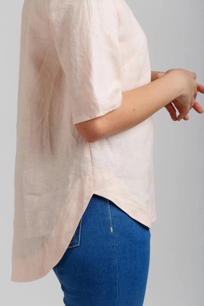 Dove blouse sewing pattern by Megan Nielsen with statement sleeve cuffs, french darts, v neckline, and curved hemline, available in three sleeve variations.