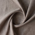 Close-up of Earthbound Chambray Linen fabric in a warm taupe stone shade, 100% linen, 145 GSM with chambray texture — close-up weave detail