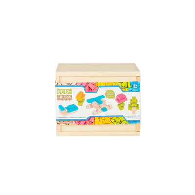 A wooden storage box with a label showing the Eco-Bricks product and its pieces, indicating it is a 54 piece color construction block set.