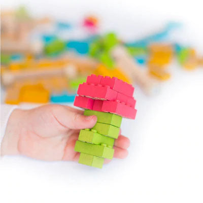A wooden storage box with a label showing the Eco-Bricks product and its pieces, indicating it is a 54 piece color construction block set.