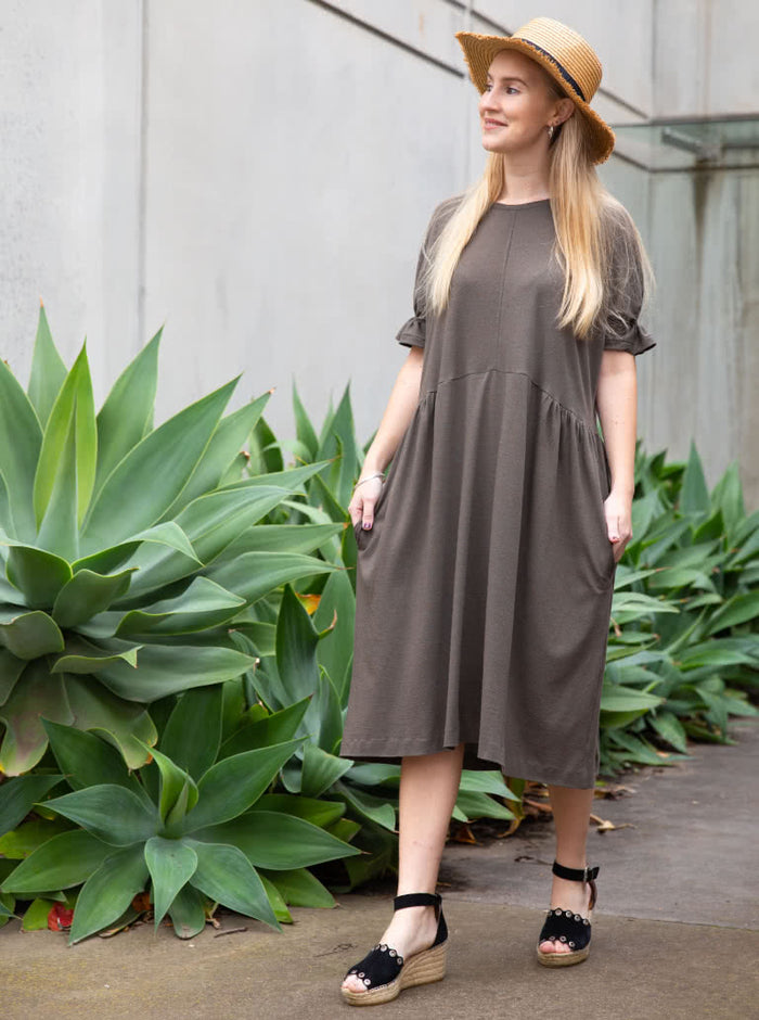 Elegant Eileen Dress pattern with shirred sleeve detail, gathered side waist, and round neckline, offering a blend of classic and modern style.