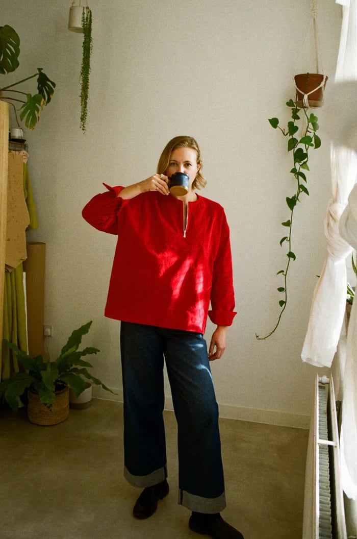 Customizable French Smock sewing pattern with options for button or zip fastening, various bib shapes, and optional trims, perfect for creating a unique garment.