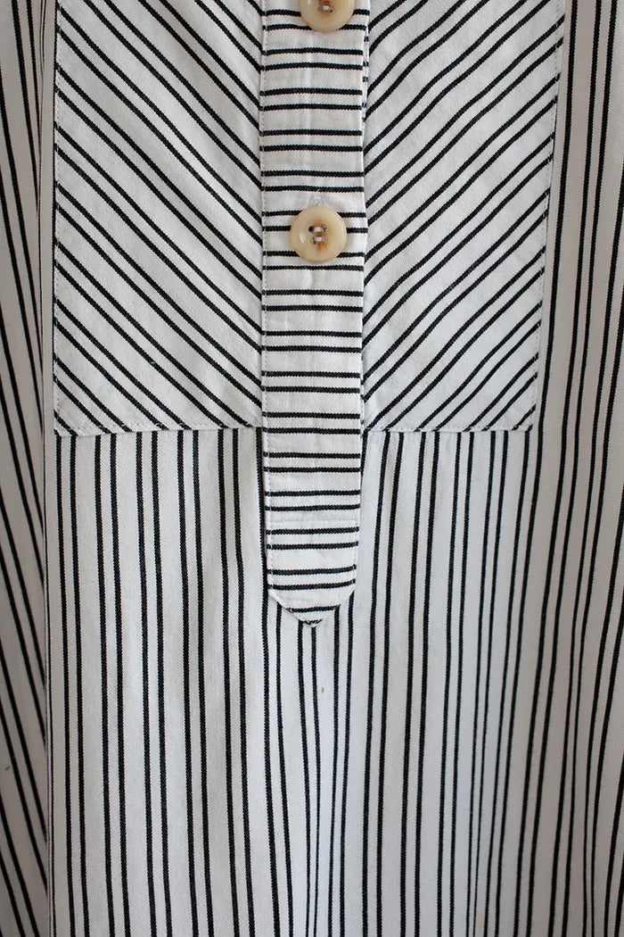 Customizable French Smock sewing pattern with options for button or zip fastening, various bib shapes, and optional trims, perfect for creating a unique garment.