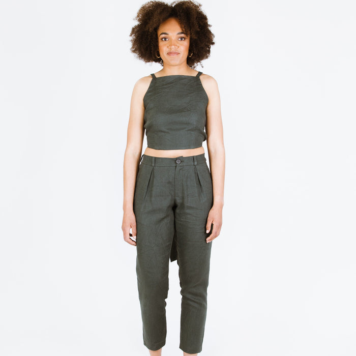 Guise Pants sewing pattern, featuring inverted pleats, zip fly, front and back pockets, and elasticated back, ideal for mid-weight woven fabrics like cotton, silk, and rayon.