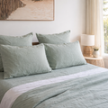 Bed with light Harbour Sage linen pillowcases  in a bedroom setting.