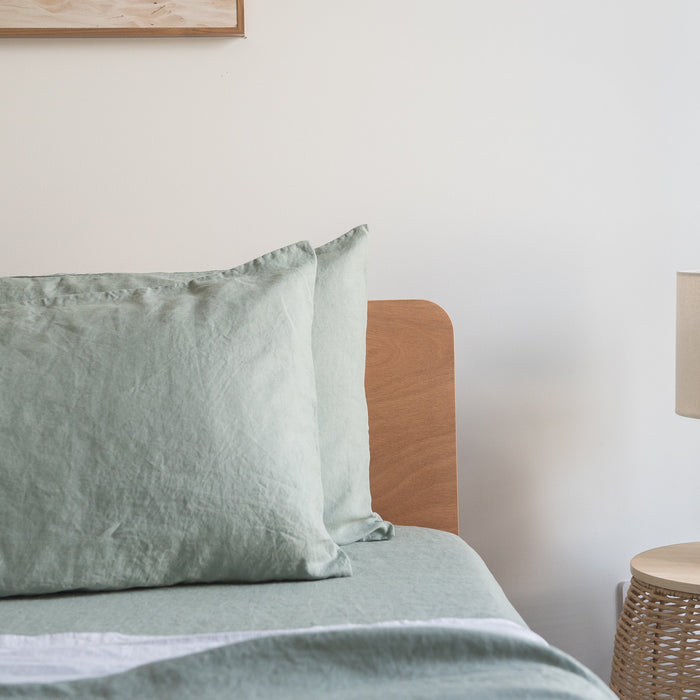 Bed with Harbour Sage linen pillowcases  in a bedroom setting