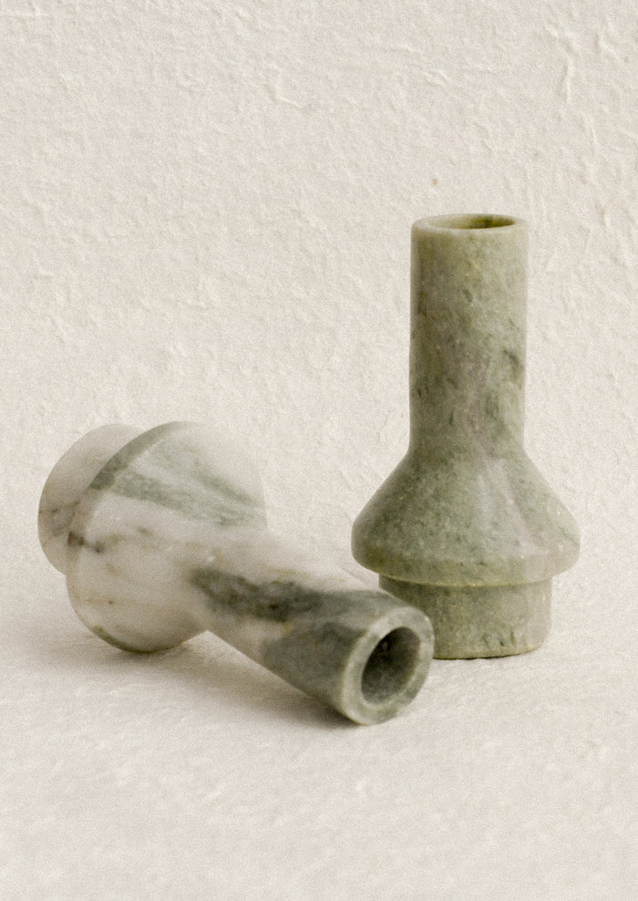 A sculptural candle holder in variegated green marble.