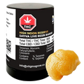 Front-lit photograph of a black jar and a dollop of golden concentrate labeled High Noon Reserve Original Z Live Resin Badder.