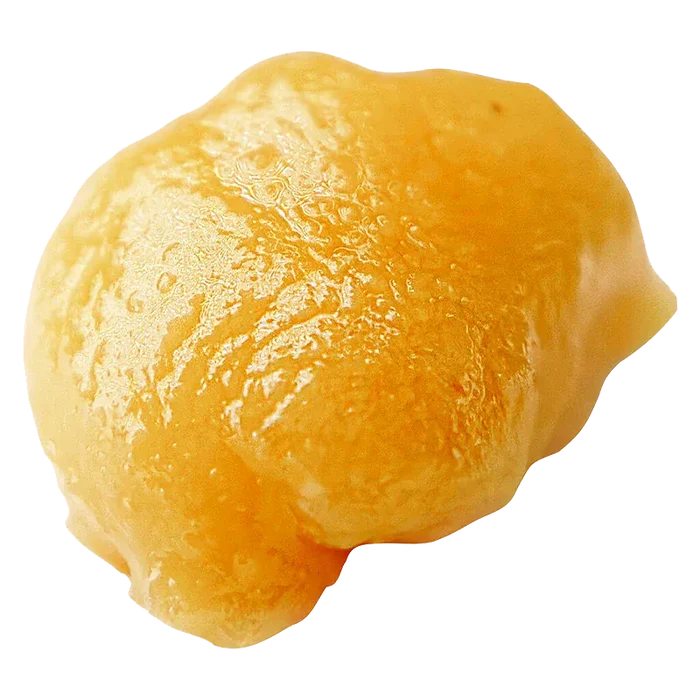 Close-up of a glossy golden globule of live resin badder, High Noon Reserve Original Z Live Resin Badder, shown on a white background.