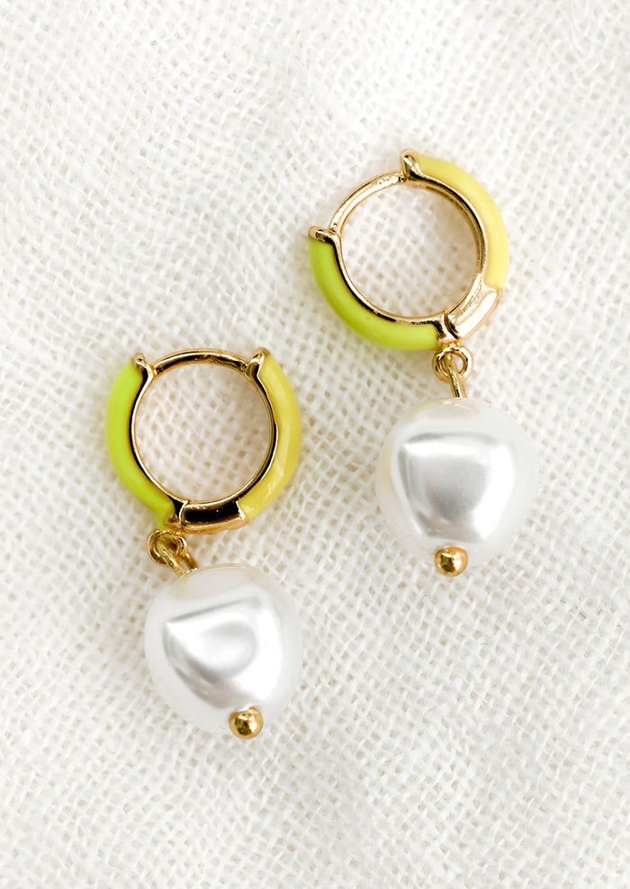 A pair of neon yellow and green huggie hoops with single pearl.