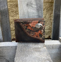 Zep-Pro University of Mississippi 1/2 Mossy Oak Camo/Brown Leather Bi-fold Wallet. Front view features:
Crazy Horse Brown Distressed Leather
Mossy Oak Break-Up Leather Print Design
Laced “Fence-row” Border between camo and brown leather
Ole Miss silver tone concho on upper right corner on camo
