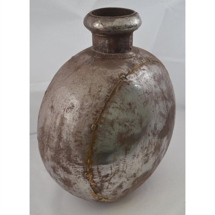 Rustic metal oval Indian water jug, close-up, antique-style finish, photographed as home decor accent.