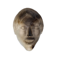 A ceramic sculpture mask depicting a young boy's face, primarily in shades of gray.