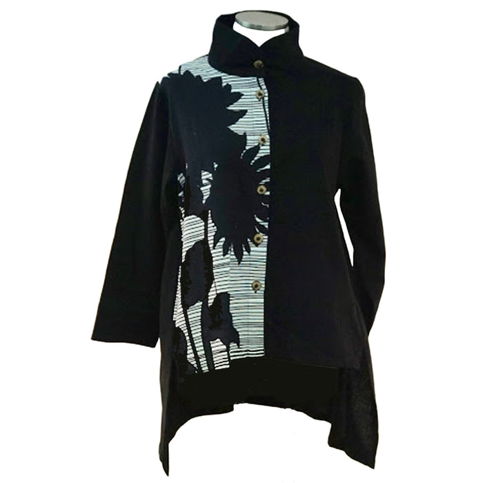A black jacket with a geometric pattern featuring a silhouette of a plant, displayed on a mannequin.