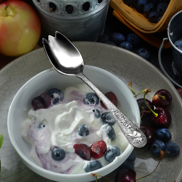 Jimothy Spork setting on bowl with yogurt and fruit.