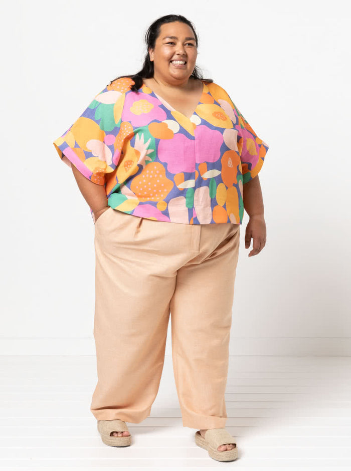 Joan Woven Top sewing pattern featuring a square shape, V-neck, extended shoulder line with band, and wide hem facings, suitable for washed linen, charmeuse, crepe, and rayon fabrics.