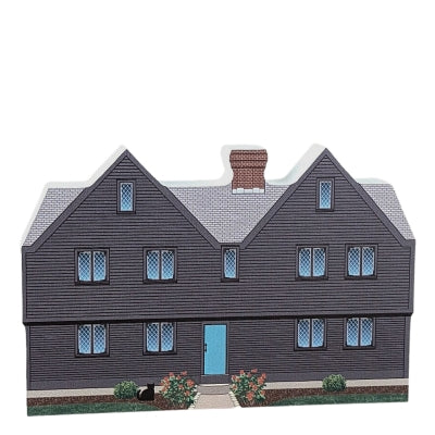 A decorative wood block of the John Ward House with informative text on the reverse.