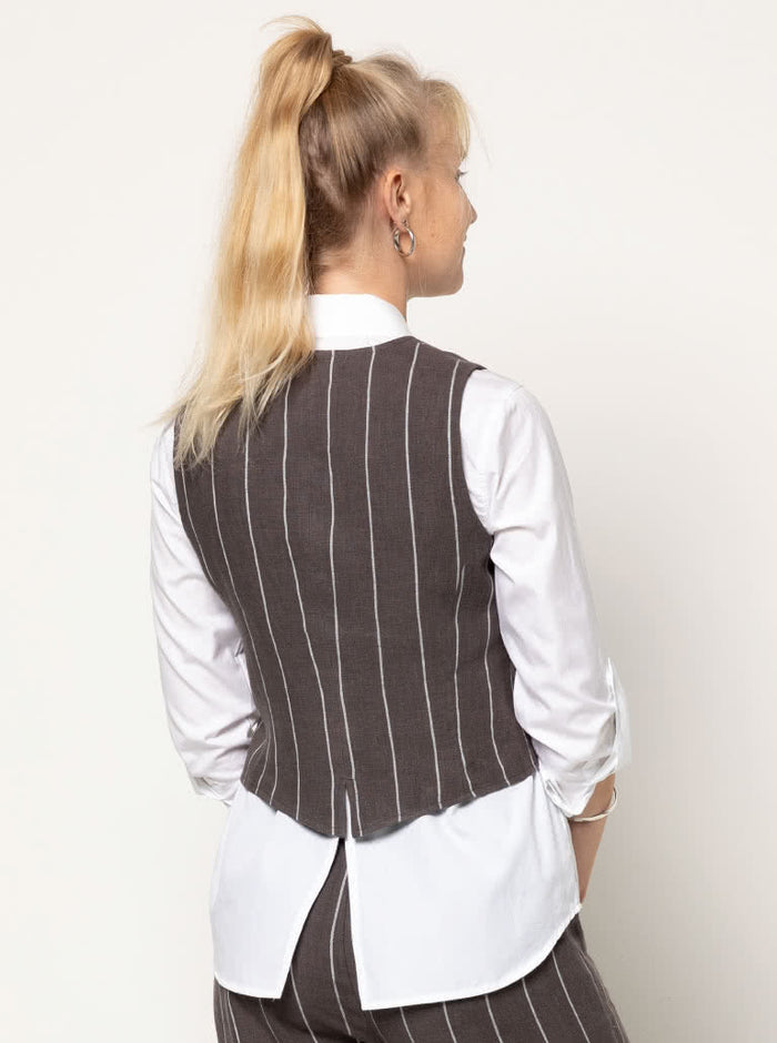 Joy Woven Vest sewing pattern featuring faux welt pockets, princess line, button opening with four buttons, cutaway at center back, easy fit, and fully lined, suitable for linen and cotton fabrics.