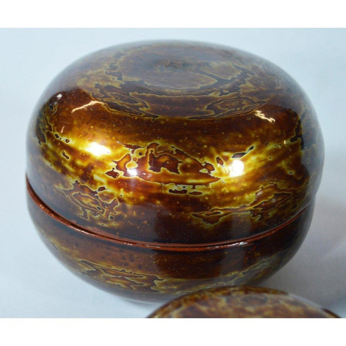 Close-up of 3 lacquered jewelry boxes with glossy marbled brown and yellow finish, Pagan-inspired design.