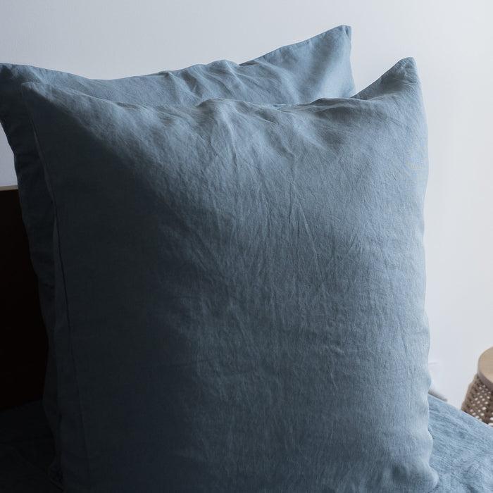 Lake Blue 100% Linen European Pillowcase on a bed with a neutral background
