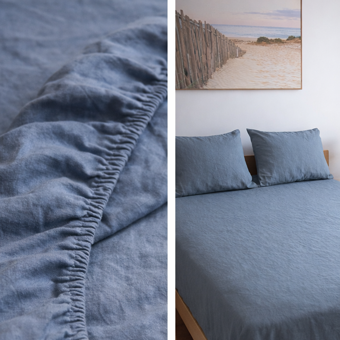 Blue bedding set with fitted sheet and pillows on a bed in a bedroom setting.