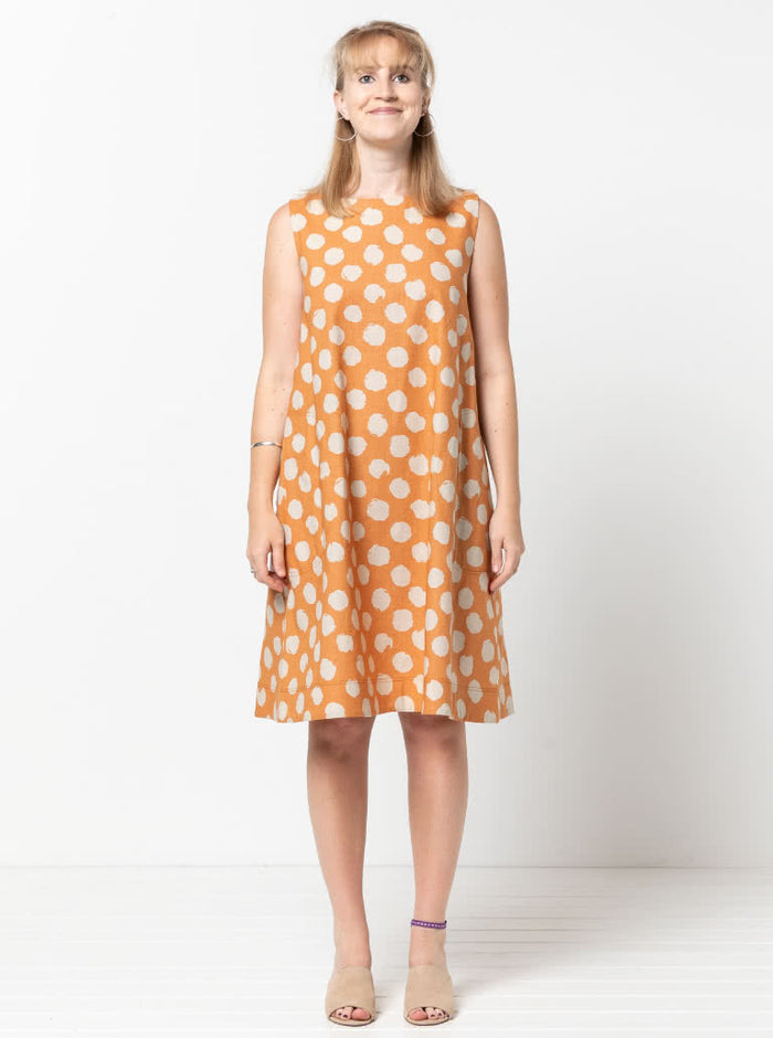 Lena Shift Dress sewing pattern, featuring a sleeveless “A” line boat neck design with a tent shape, calf length, and large inseam pockets, suitable for linen, cotton, and crepe fabrics.